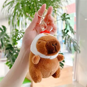 Handheld Capybara plush keychain wearing a white chicken hat with metal lobster clasp