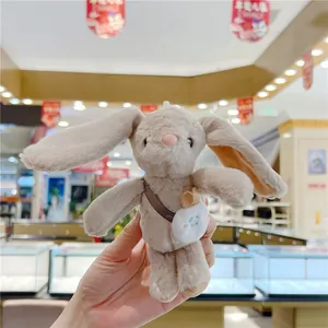 Detailed close-up of plush long-eared bunny toy with cute cloud shoulder bag accessory