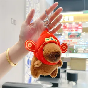 Plush Capybara keychain with red hat and gold coins for wealth and good luck