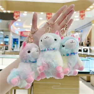 Three colorful plush alpaca keychains with macaron gradients and gold lobster clasps