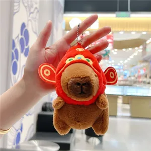 Chubby capybara plush keychain wearing a festive red Chinese style hat with bead chain