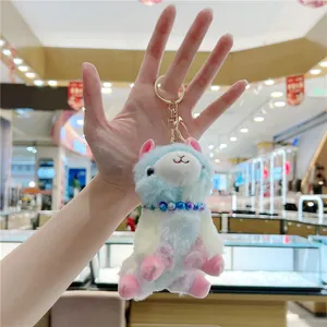 Detail of colorful gradient alpaca plush keychain with golden metal hook and bead necklace