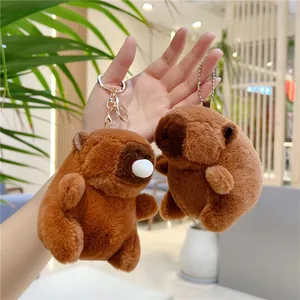 Détail de porte-clés capybara en peluche marron avec fourrure douce et clips