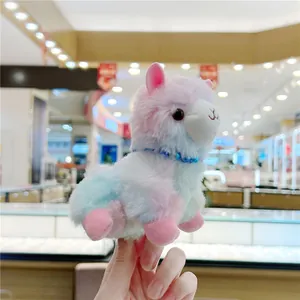 Detail of colorful gradient alpaca plush keychain with a beaded necklace and soft fur texture