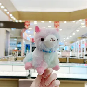 Detail of colorful macaron alpaca plush keychain with soft fur and beaded necklace