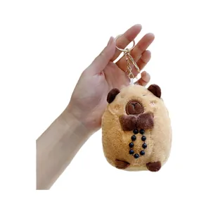 Cute Capybara plush keychain with dark bow and black beads on a soft brown body