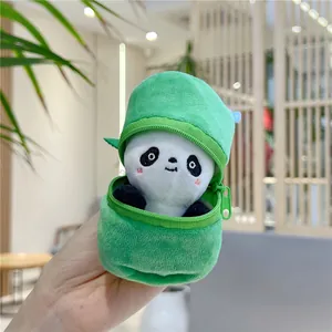 Close-up of a plush panda doll being tucked into a green bamboo shoot zipper pouch