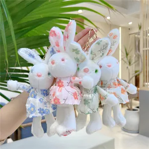 Set of four plush bunny keychains in floral dresses with golden metal hooks for bags