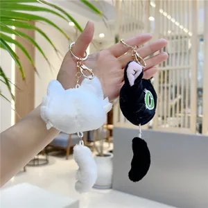 Cute black and white plush cat keychains set with soft fur and golden metal rings
