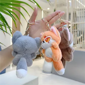 Three cute plush fox and wolf keychains in grey, orange, and brown with gold metal hooks