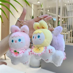 Cute plush rabbit keychains in pink, yellow, and purple with lace bibs and fruit embroidery
