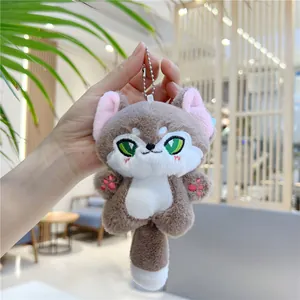 Close-up of cute grey plush fox keychain with soft fur texture and embroidery details