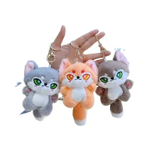 Three colorful plush fox and wolf keychains with embroidery details and gold metal clips