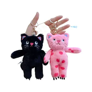 Pair of cute polka dot plush cat keychains in pink and black for backpack decor