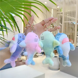 Plush rainbow shark keychains in colorful gradient styles with gold metal clasps
