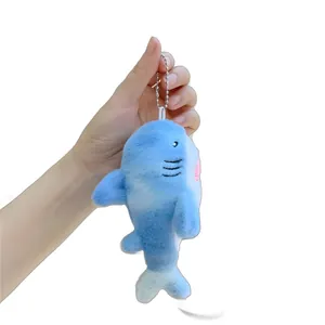 Cute blue shark plush keychain with metallic bead chain, shown in hand display