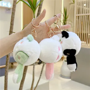 Close-up of three cute plush cat keychains with soft faux fur and gold metal clips