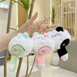 Plush cat keychains in green, pink, and panda colors with golden metal lobster clasps