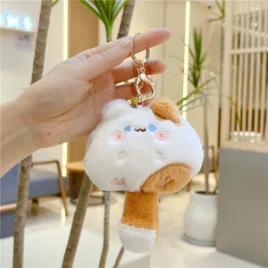Close-up of mushroom cat plush keychain with soft fur texture and golden lobster clasp