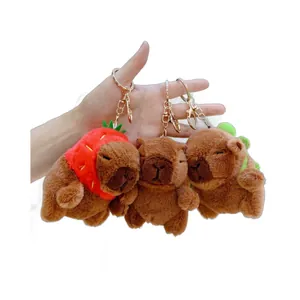 Three cute capybara plush keychains with strawberry and leaf hats for bags or keys