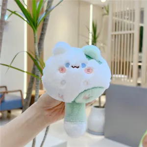 Close-up of a soft white and mint green plush cat keychain with embroidered details
