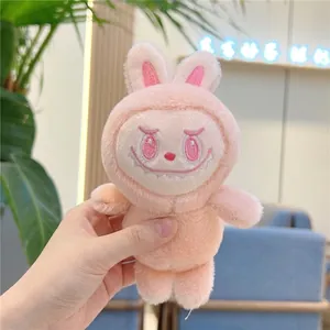Close-up of pink plush rabbit keychain with detailed embroidery and fluffy texture