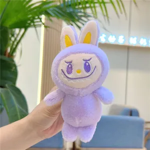 Close-up of purple plush monster keychain with signature jagged smile and soft rabbit ears