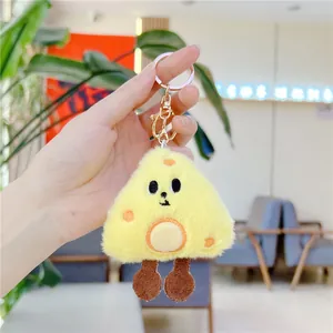 Close-up of cute plush cheese keychain with embroidered face and golden metal hook