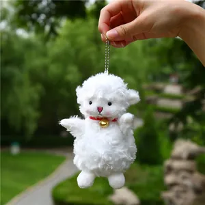 White fluffy lamb plush keychain with a red collar and a small golden bell