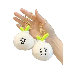 Cute garlic plush keychains with expressive faces and green leaf details on white background