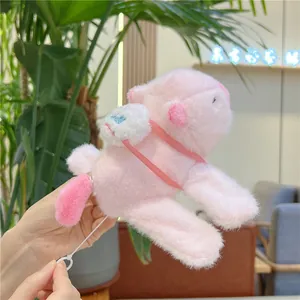 Detail of pink Capybara plush with small bag and drawstring mechanism for tail rotation