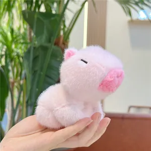 Detailed close-up of a pink capybara plush toy with soft texture and pig-like features