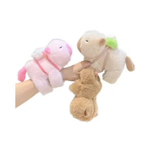 Three colorful plush capybara wristbands shown on arm with soft velvet texture