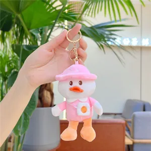 Cute white plush duck keychain with pink sun hat and crossbody bag accessory