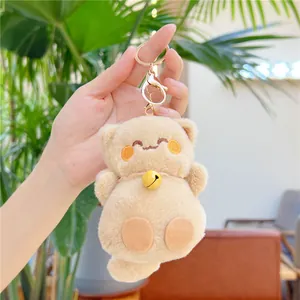 Détail d'un porte-clés chat Maneki Neko en peluche avec clochette dorée et clip