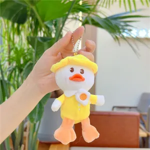 Close-up of plush duck keychain with yellow hat and poached egg embroidery detail