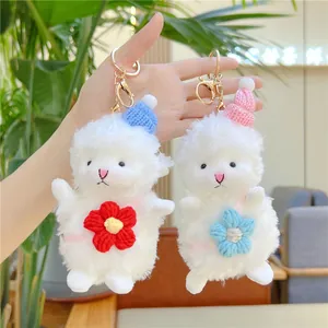 Set of two cute plush sheep keychains with knitted hats and colorful flower accessories