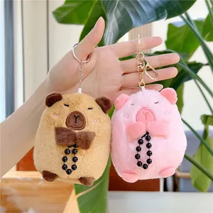 Cute Capybara plush keychains in brown and pink colors with soft fur and metal clips