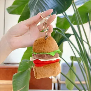Detailed view of plush burger keychain featuring multi-layer felt and metal clasp