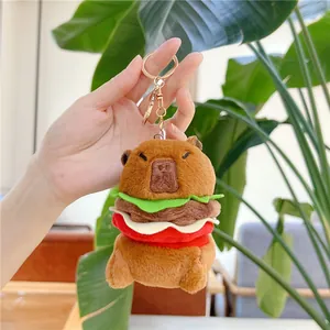 Detail of Capybara burger plush keychain with soft layered lettuce and tomato fabrics