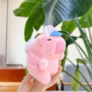 Detailed view of pink plush capybara keychain wearing a mini blue and white baseball hat