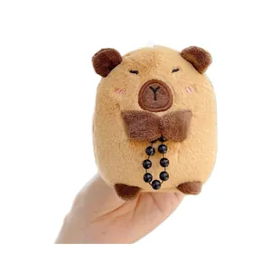 Cute capybara plush keychain toy with a bow and beads on a clean white background