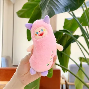 Pink plush monster keychain detail with purple horns and Rainbow embroidery