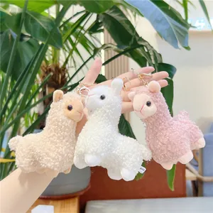 Cute alpaca plush keychain set in white, apricot, and pink with fluffy fur and gold clasp