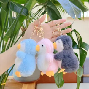 Cute fluffy penguin plush keychain set in blue pink and grey colors with gold ring