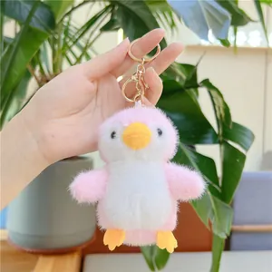 Cute pink and white fluffy penguin plush keychain with golden metal clasp and ring