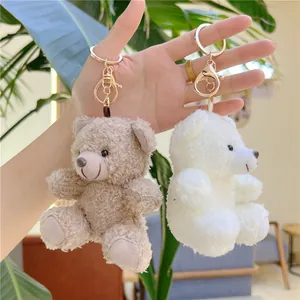 Curly plush teddy bear keychain set in white and brown with gold metal ring hooks