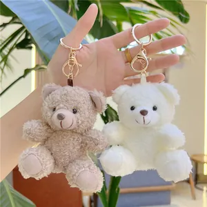 Curly plush teddy bear keychain charms in brown and white with gold lobster clips