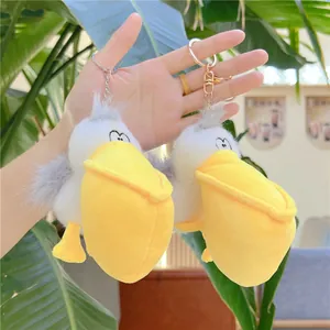 Cute pelican plush keychain set with soft white fur and yellow beak for bag decor