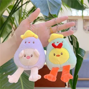 Cute plush keychain with purple pig and green chick designs on a tropical background